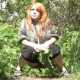 A red head woman is recorded taking a shit while squatting under cover of vegetation in an outdoor location. The view shows poop action quite clearly. Nice video! Over a minute.